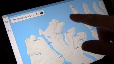 Man Looking At Map Of Town On The Faroe Islands On Tablet Computer Stock Footage 114654617