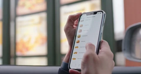 Man looking for menu in McDonalds app. Minsk, Belarus - December 28, 2022 Stock Footage 265267844