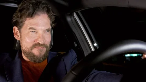 Man looking mirror car believing to be very good looking driving at night Stock Footage 76004264