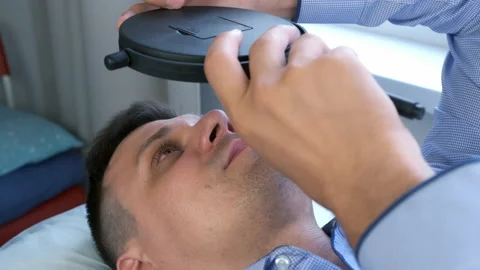 Man looking at mirror on his lashes after eyelash laminating lifting procedure. Video stock 158395087