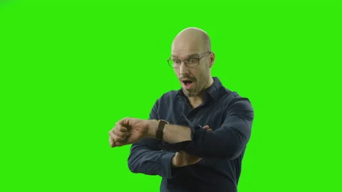 A man looking nervous at his clock noticing he ist too late Stock Footage 166511799