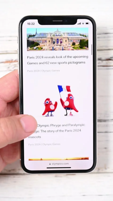 Man looking on the official website of Paris Olympic Games 2024 on mobile Stock Footage 242503887