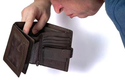 Man looking into open empty wallet, poverty and bankruptcy concept Stock Photos