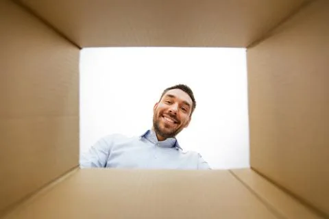 Man looking into open parcel box 库存照片