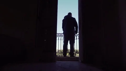 Man looking out an old balcony Stock Footage 73646225