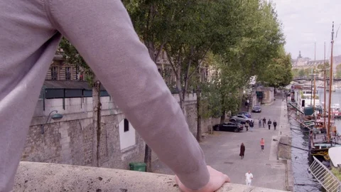 Man looking out over Paris leaning with hand on bridge. Stock Footage 118368544