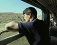 Man looking out of train window at countryside SD Footage