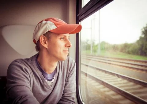 Man looking out of the train window Stock Photos