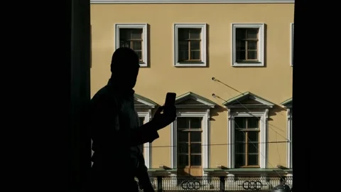 Man looking out the window in the backlight Stock Footage 238374672