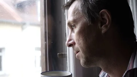 Man Looking Out Window Drinking Coffee Stock Footage 72472838