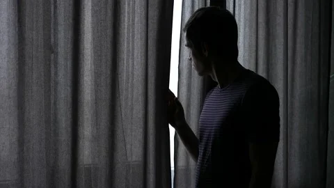 Man looking out of the window Video stock 148336440