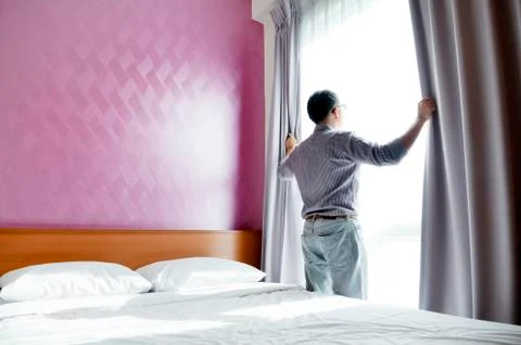 Man looking out of window Stock Photos