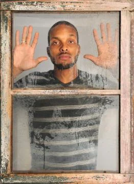 Man looking out window Stock Photos