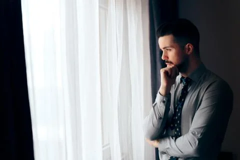 Man Looking out the Window Thinking of the Future Stock Photos