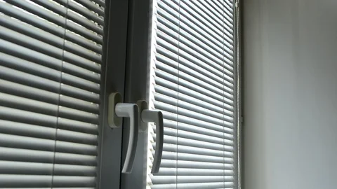 Man looking out the window through the blinds to the street, spying. suspected Stock Footage 89135740