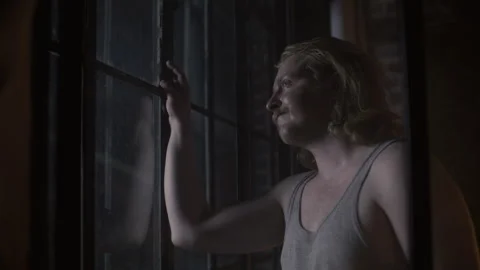 A man looking outside the window and looking sad Video stock 259689632