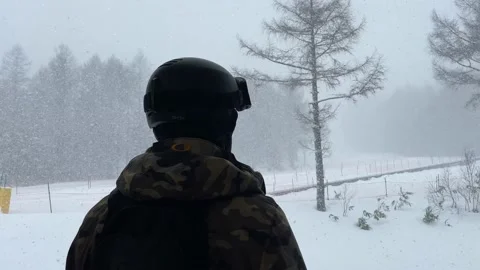 Man looking outside the window in winter 動画素材 234314075