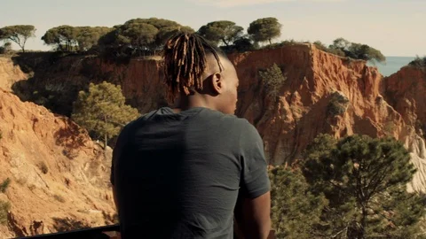 Man Looking over cliffs Stock Footage 114003524
