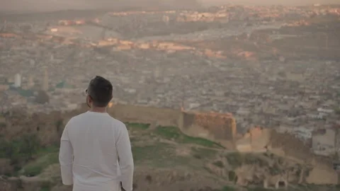 Man looking to Panoramic view of Medina Old Town Fes Fez Morocco during Sunset Stock Footage 260947677