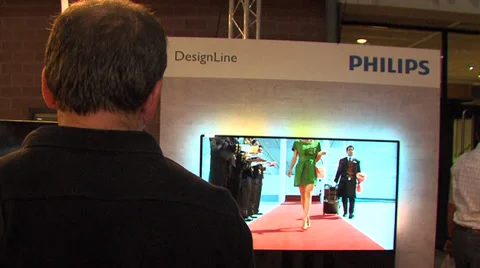 Man looking at philips tvstand Stock Footage 32704128