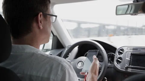 Man Looking at Phone While Driving Stock Footage 65965000