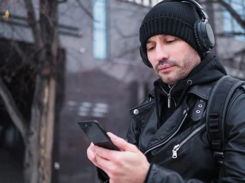 Man looking for a place using GPS map in smartphone. He lost in unknown city. Stock Photos