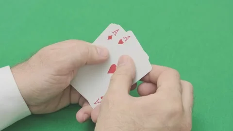 Man is looking at playing cards four aces Stock-Footage 265879357