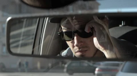 A man looking in the rearview mirror. Stock Footage 51756708