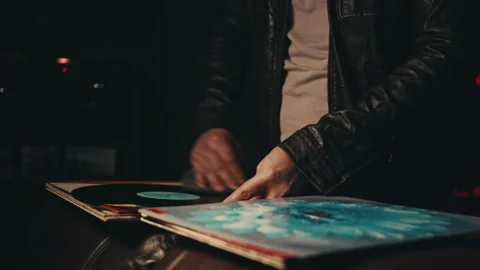 Man looking at records in a 80s setting and wardrobe Video stock 293265751