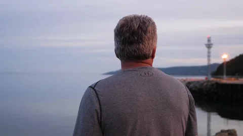 Man looking at river lake sunset light shore beautiful landscape water nature Stock-Footage 156144669