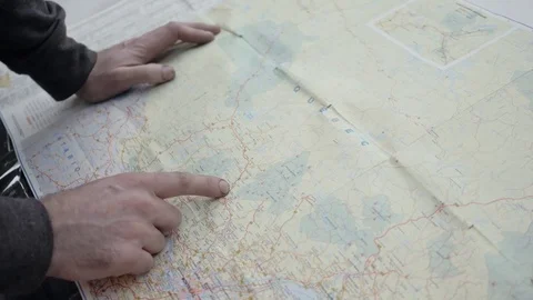 Man Looking on a Road Map on The Hood Of His Car Closeup Stock Footage 75967461