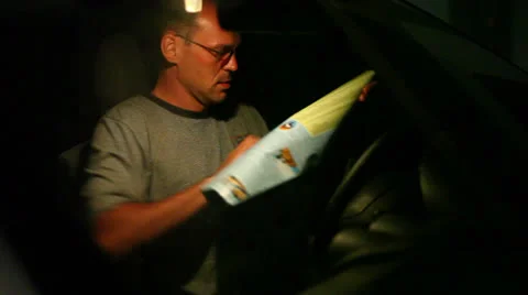 Man looking at the road map at night 스톡 동영상 26387843