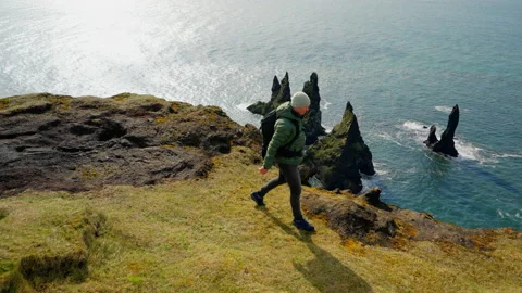 Man Looking At Rock Formations On The Sea Stock Footage 234136591