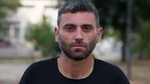 Man looking seriously into the camera, conveying a sense of determination Stock Footage 284236580