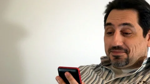 Man looking at smartphone and smiling Stock Footage 93098933