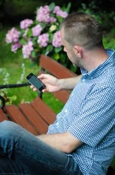 Man looking at smartphone Stock Photos