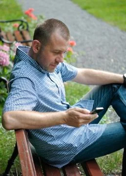 Man looking at smartphone Stock Photos