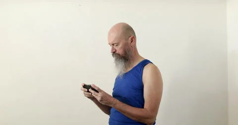 Man looking into smartphone prior physical exercise Stock Footage 236781140