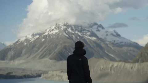 Man looking at snow covered mountains Stock Footage 95013537