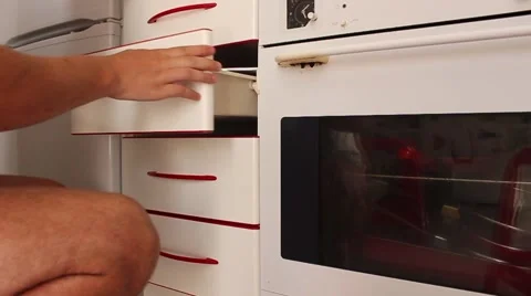 Man looking for something in the drawers in the kitchen Video stock 65302091