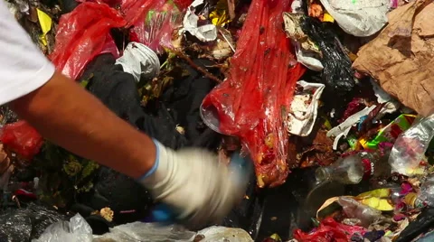 Man looking for something in Garbage Видео 50637758