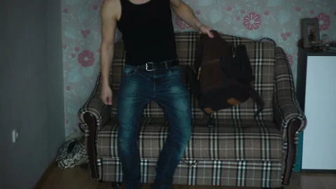 Man is looking for something in his backpack and does not find 스톡 동영상 87403793