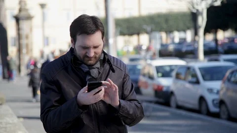A man looking for something on the phone, commenting  Stock Footage 102275888