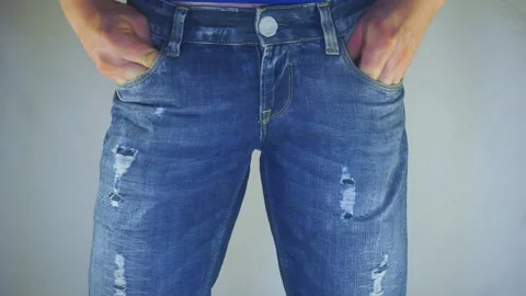 Man is looking for something in the pockets of jeans. Video stock 102457376