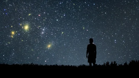 Man looking at the stars. Alone man looking at starry sky. Night sky. Stock Footage