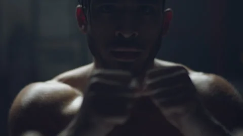 Man looking straight at the camera while practicing his punching moves Stock Footage 279846915