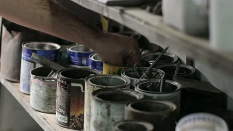 A man is looking for a suitable bolt to tighten a part Stock Footage 214086140