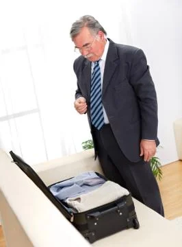 Man looking at suitcase Stock Photos