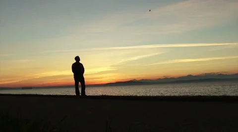 Man looking at sunset beach. Walking around.  Stock Footage 2334449