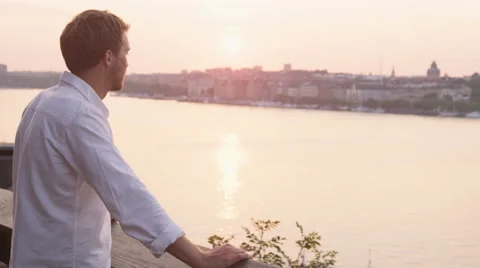 Man looking at sunset enjoying view of Stockholm relaxing enjoying calm Stock Footage 45784640
